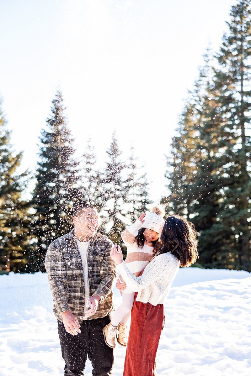 Cute family playing in the snow