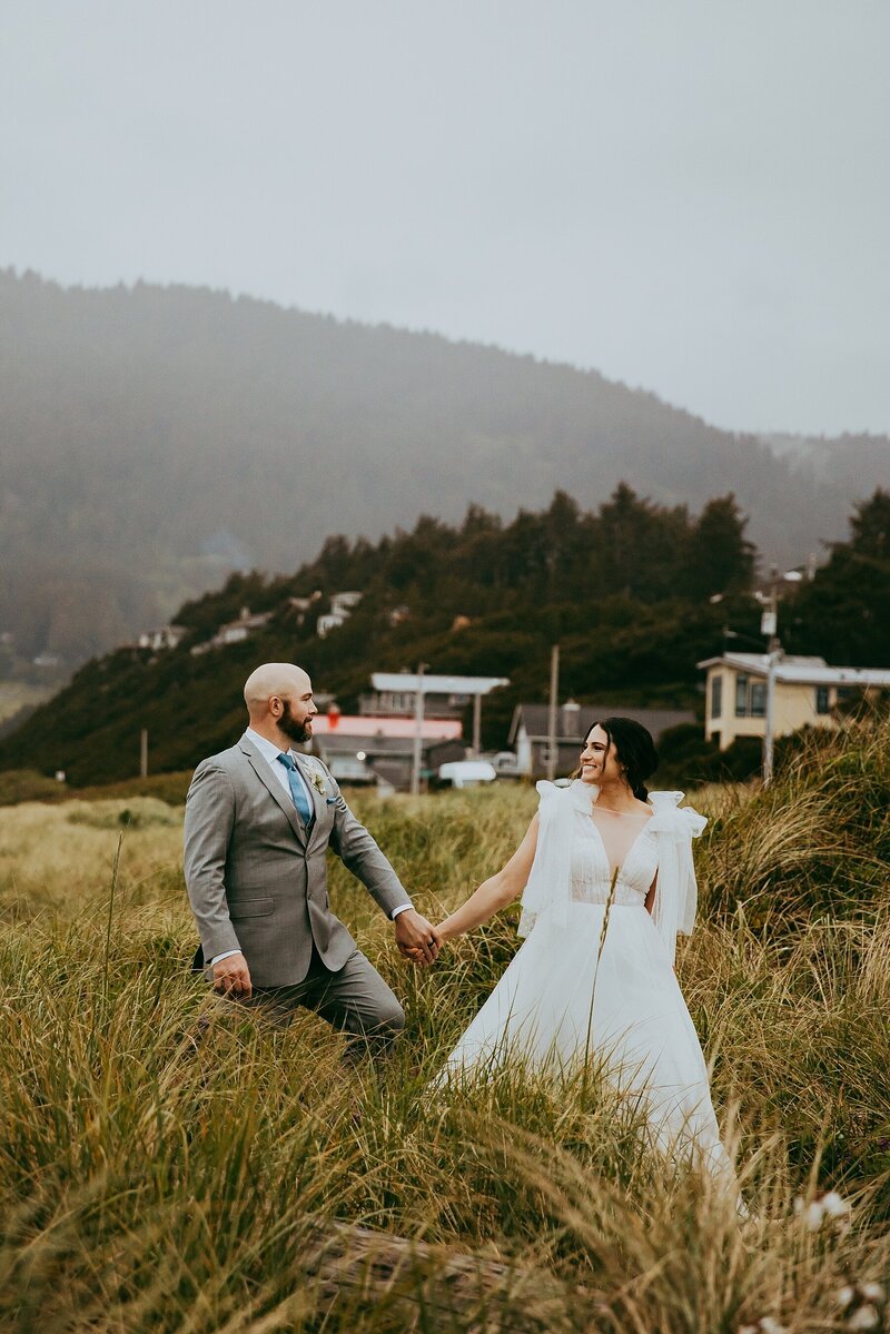 couple walking through field in Oregon