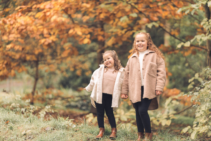 kids posing in autumn leaves