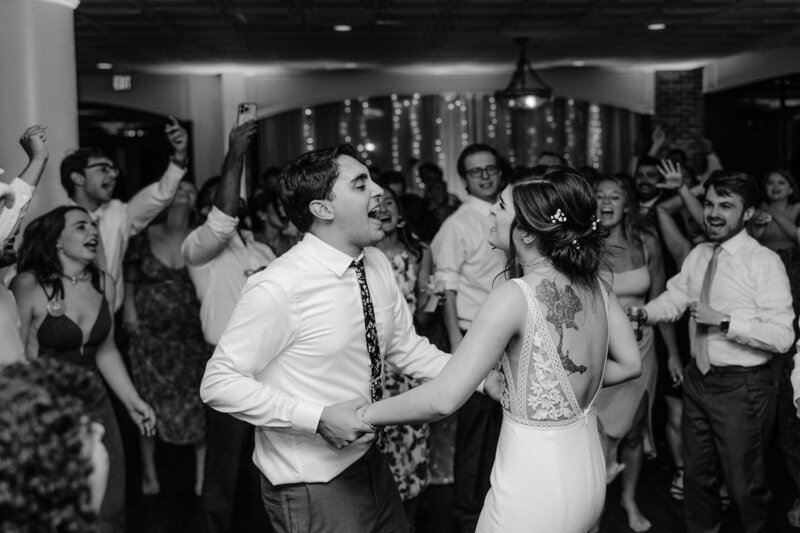 Newly weds happily dancing on their wedding day captured in a candid moment by Get Ready Photo