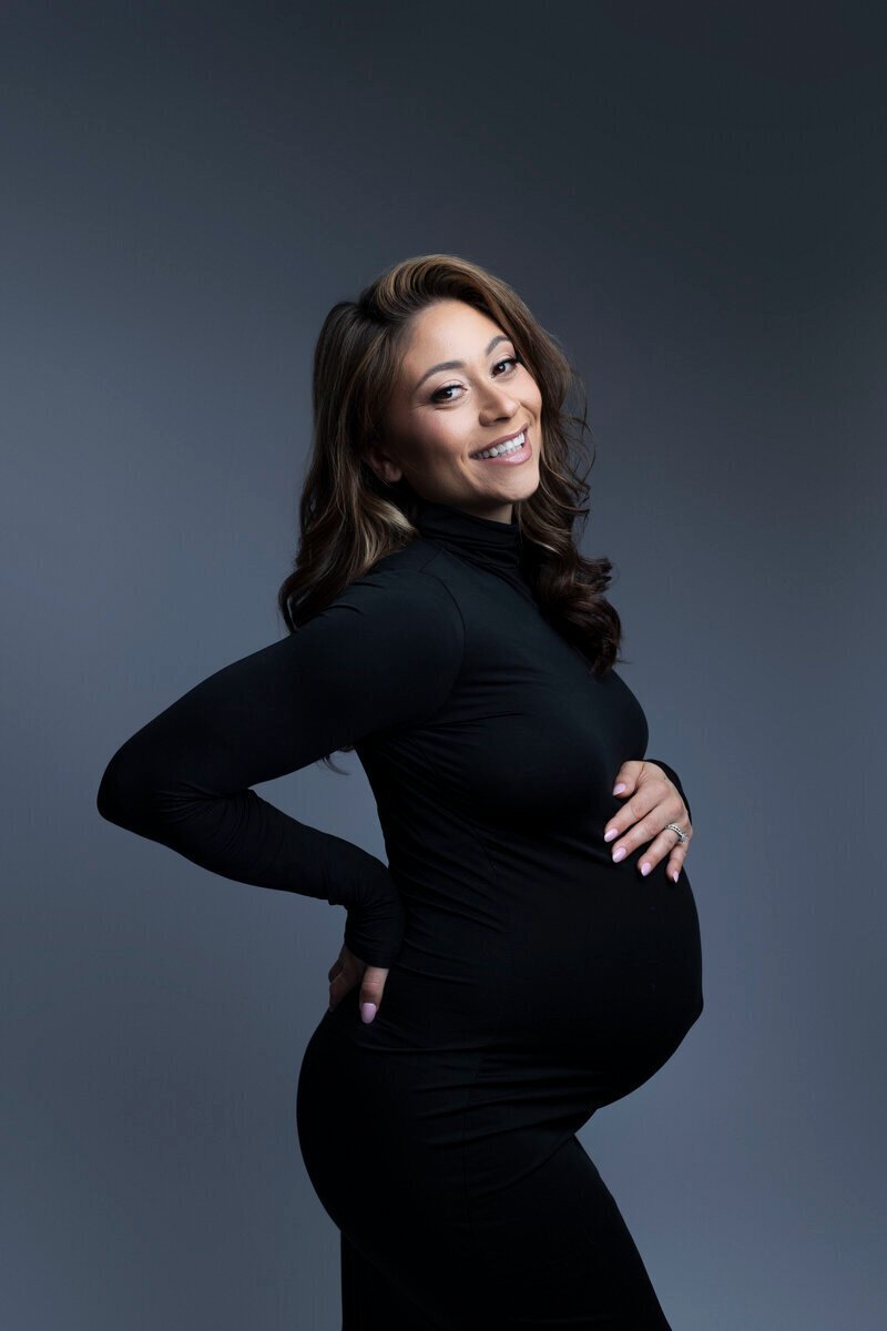 Pregnant woman holding baby bump and back, taken by nj maternity photographer
