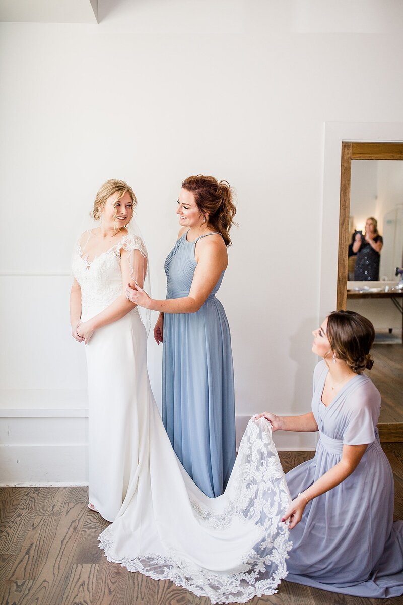putting on the dress by Knoxville Wedding Photographer, Amanda May Photos
