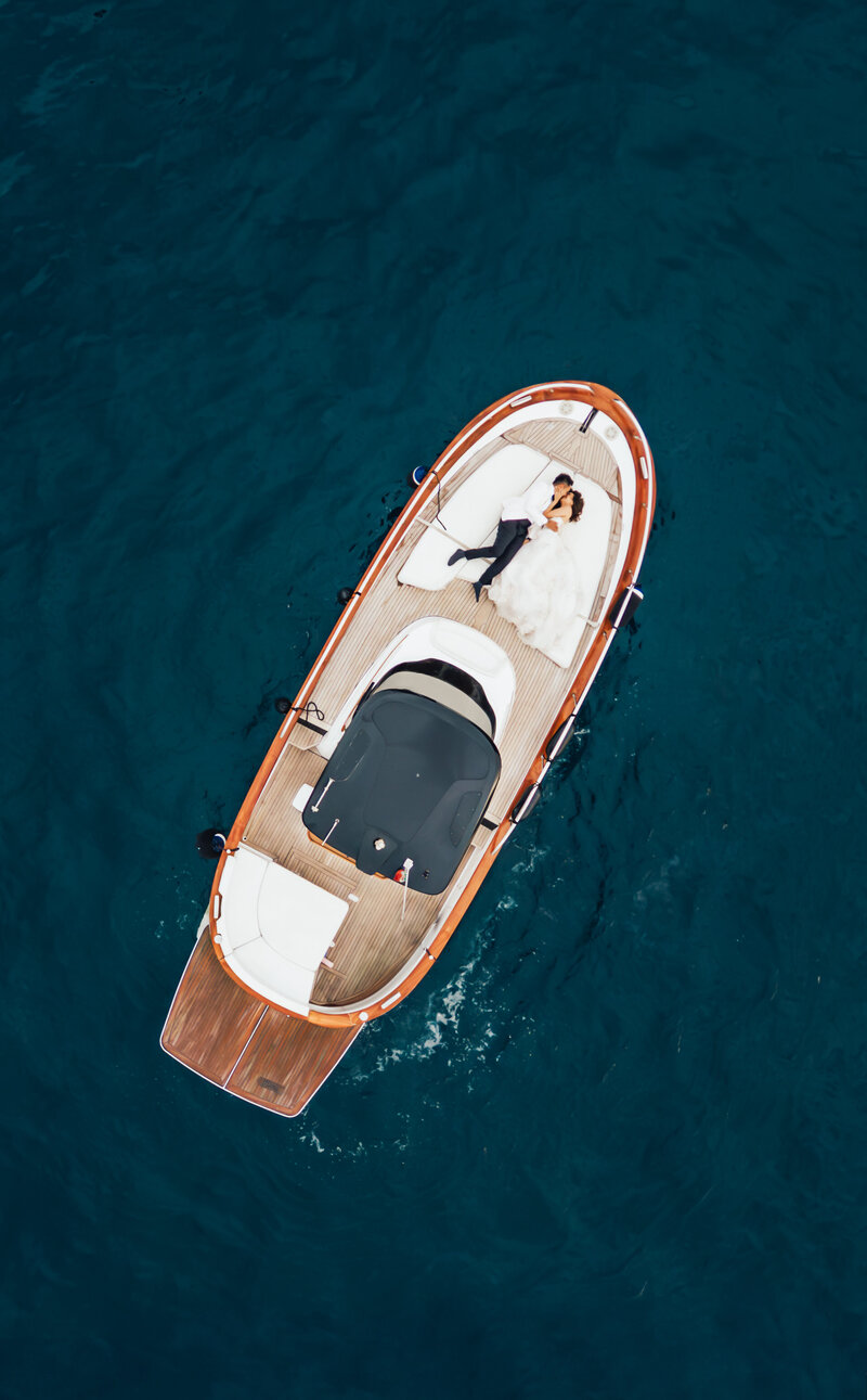 drone shot of bride and groom on boat