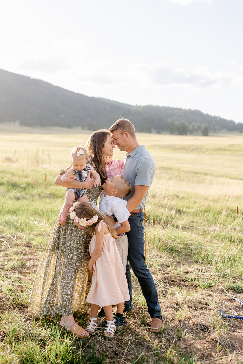 Family of four playing together during a family portrait session in Littleton Colorado