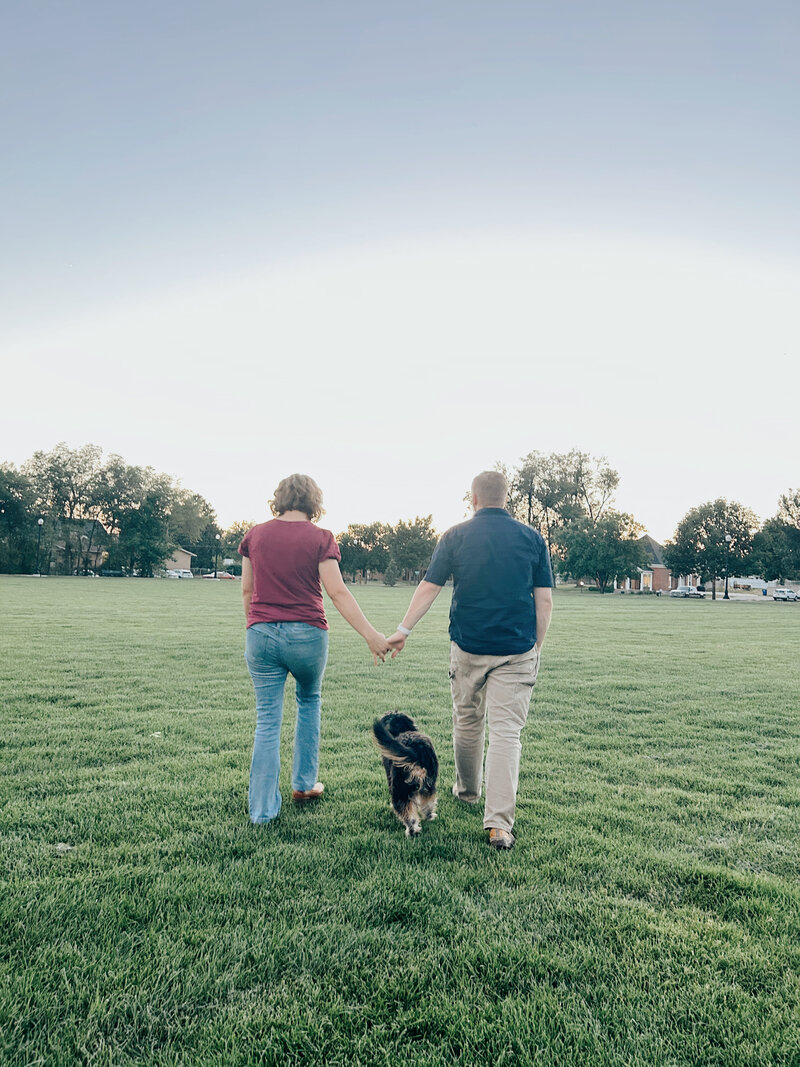 Cornerstone dog training owners holding hands and walking with puppy at their side | Cornerstone Dog Training