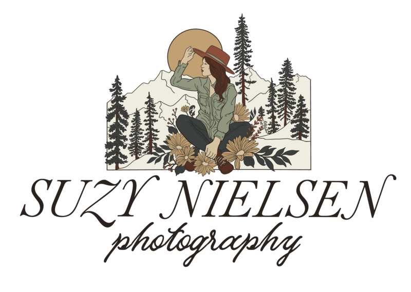 Family & Maternity Photographer, Suzy Nielsen Photography Logo, a graphic of a woman sits in the mountains in the trees