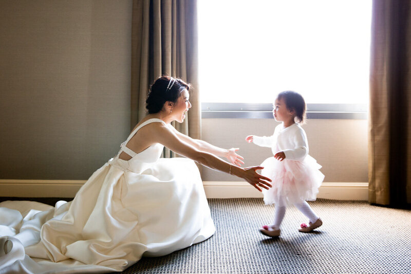 Bride open arms to her daughter as she walk towards her