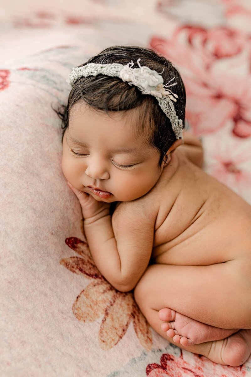 Close up baby girl image of hair eyelashes and the sweet rolls on a flower background
