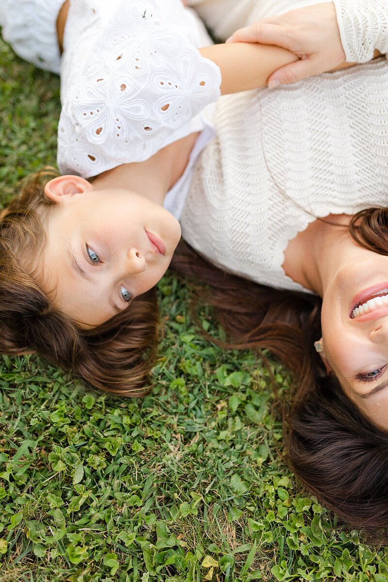 A mom and daughter snuggling and laughing during an in-home family session at Lexington KY.