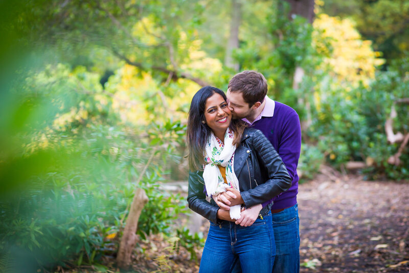 couple in loving embrace in the woods at Bushy Park on their pre-wedding shoot
