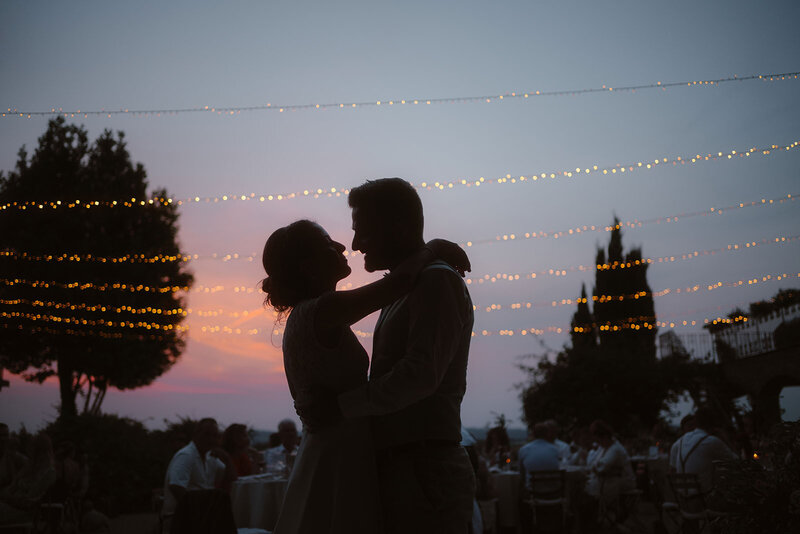 newlyweds silouetted against the evening sky on their wedding day in Italy