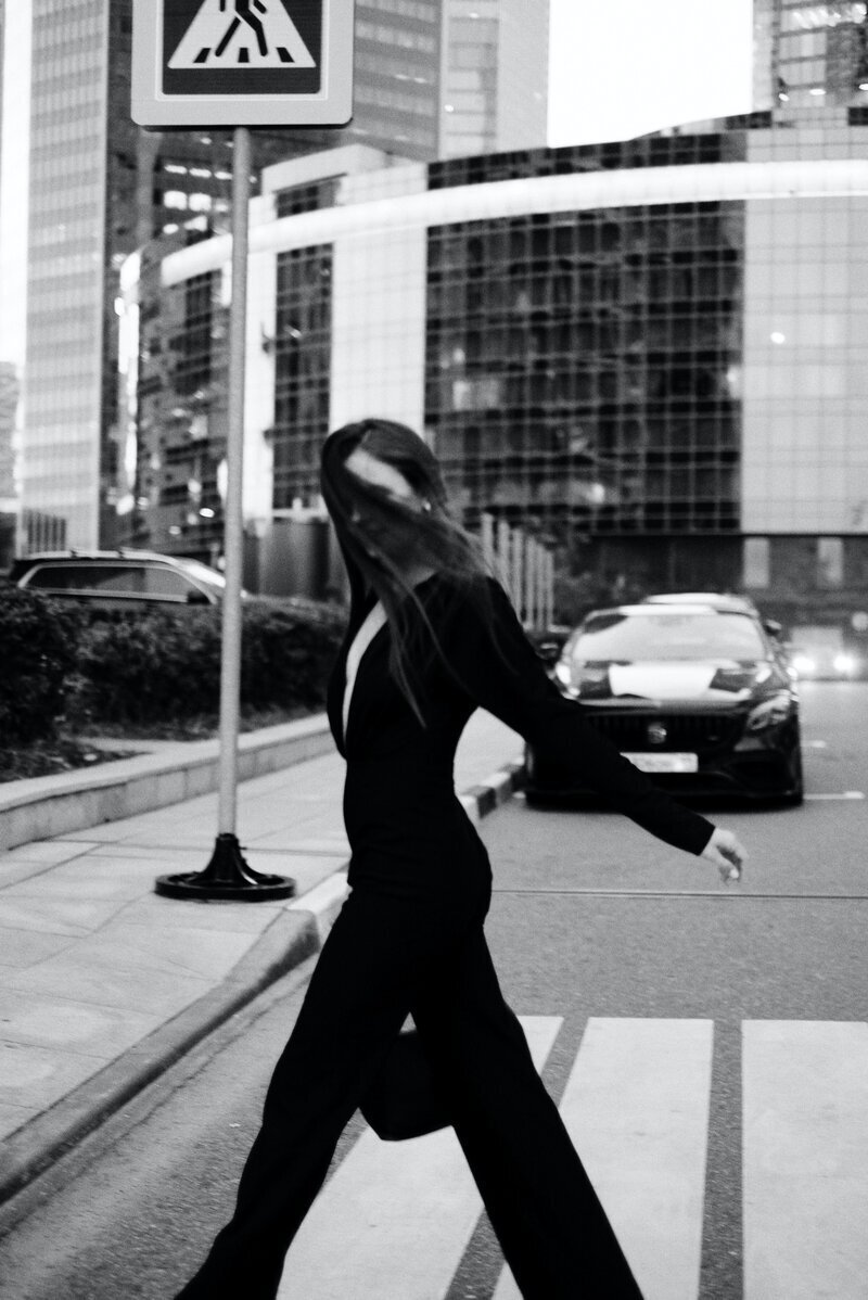 Stylish empowered woman walks across a street