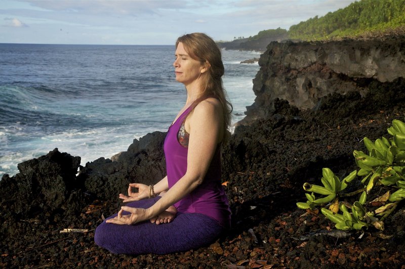 Liz Heffernan, Founder of Soma Yoga Institute Meditating on the Beach in Hawaii