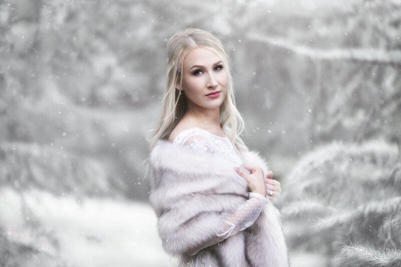 Fine art portrait of Blonde woman with fur and wedding dress in snow at the Dallas Arboretum