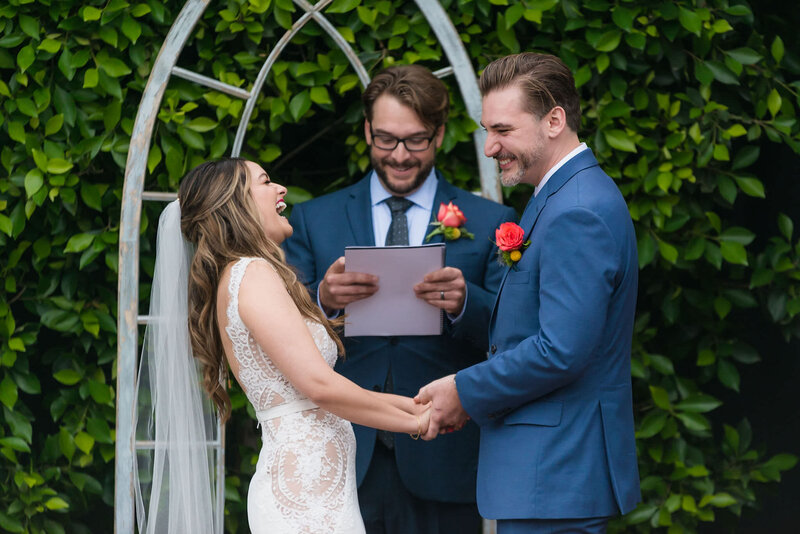 Bride and groom laugh while taking their vows