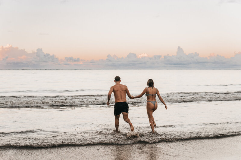 Ben & Maddie having fun at the beach during their Oahu elopement.