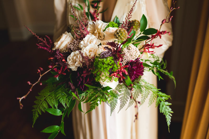 Bride with burgundy and blush garden style bouquet