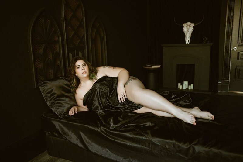 woman in silk black sheets for boudoir