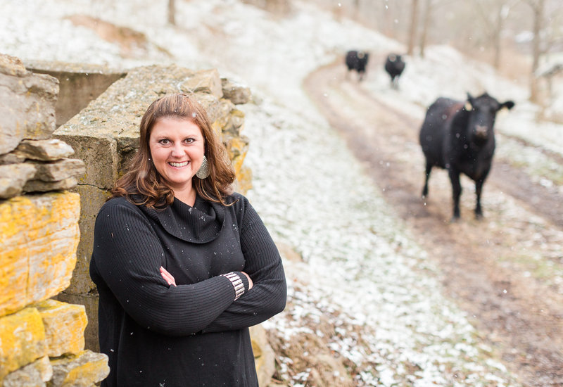 Professional public speaker Paige J. Pratt poses for a photo with the cattle on her farm.