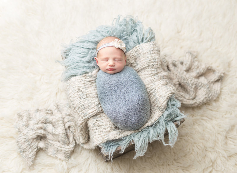 Bbay girl wrapped in grey and blue posed studio