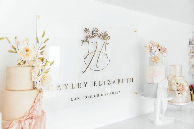 Wall sign with gold floral logo  in luxury branding