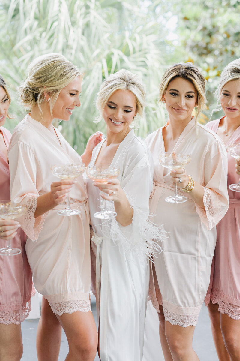 Bridesmaids getting ready with champagne glasses