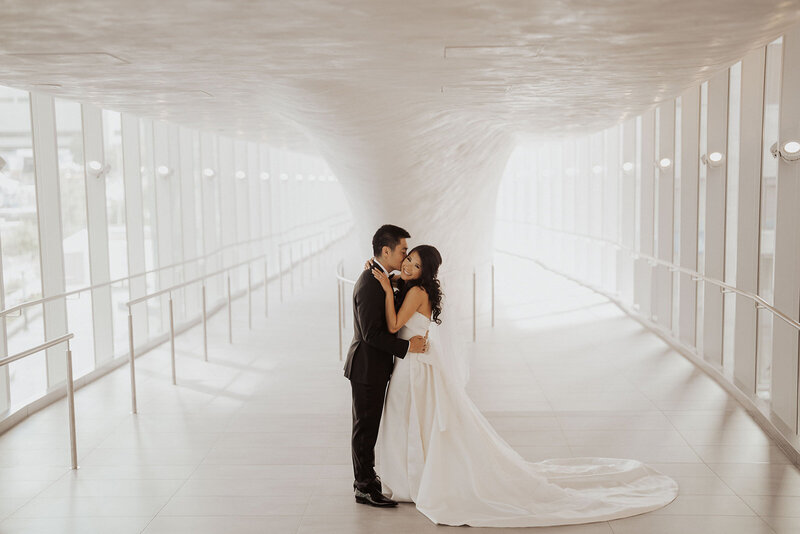Couple kissing in a modern tunnel.