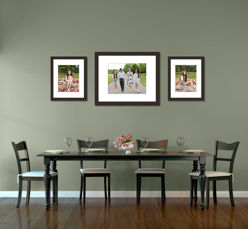 Dining room table and chairs with photo display on the wall