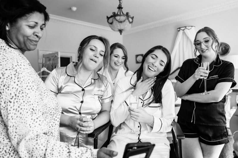 Bridal party laughing with mother of the bride
