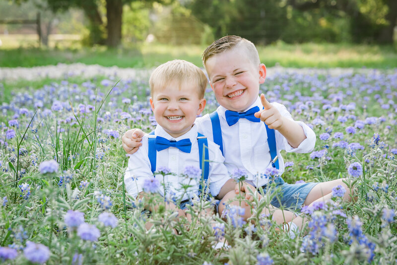 Brothers wearing blue bowties in bluebonnet field, Austin Family Photographer