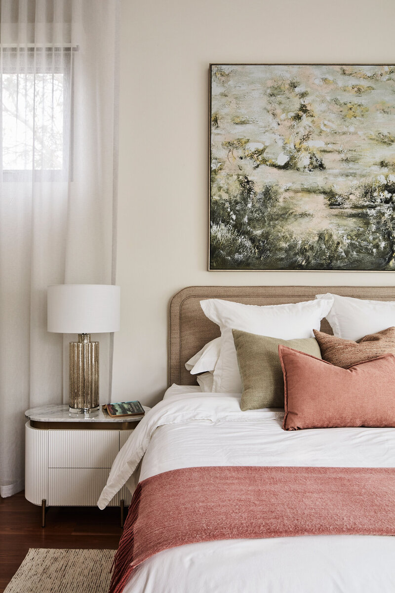 Melbourne interior designer turnkey furnish and style bedroom project with neutral tones, artwork, and layered bedding.