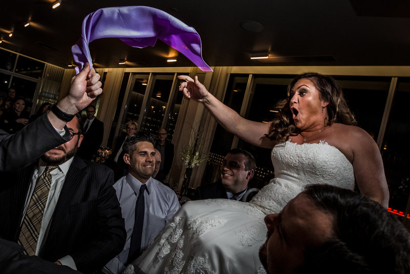 Bride being lifted on chair jewish wedding