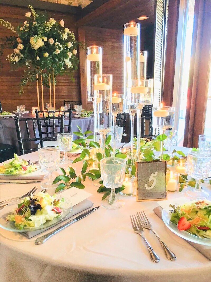 Venue Dining Guest Table with Tall  Stemmed Candleholders at Palafox Wharf Waterfront Venue in Pensacola FL