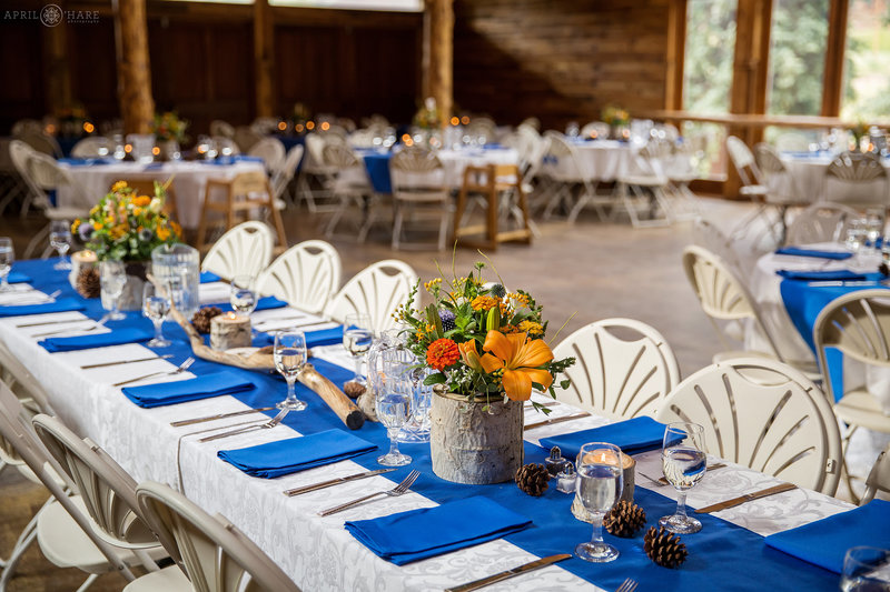 Orange and blue wedding decor for a rustic barn wedding in Colorado