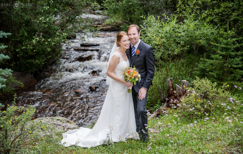 Beautiful couples portrait in front of Elk Creek at Mountain View Ranch in Colorado