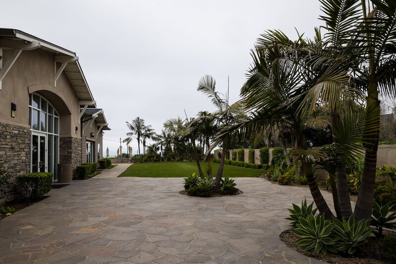 The Ocean Lawn wedding ceremony site and palm trees at Cape Rey Carlsbad Beach wedding venue.