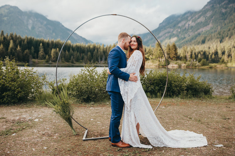 Couple stands by lake for Washington elopement