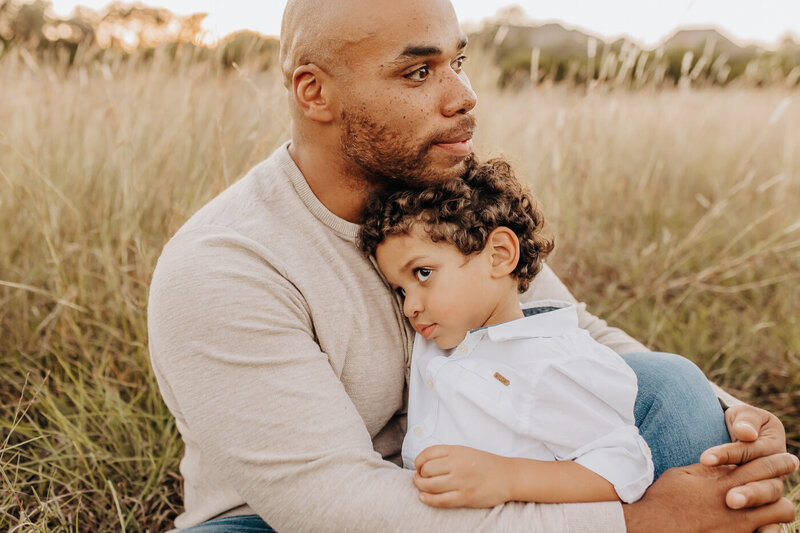 Father and son in a San Antonio grassy field for a sunset photography session.