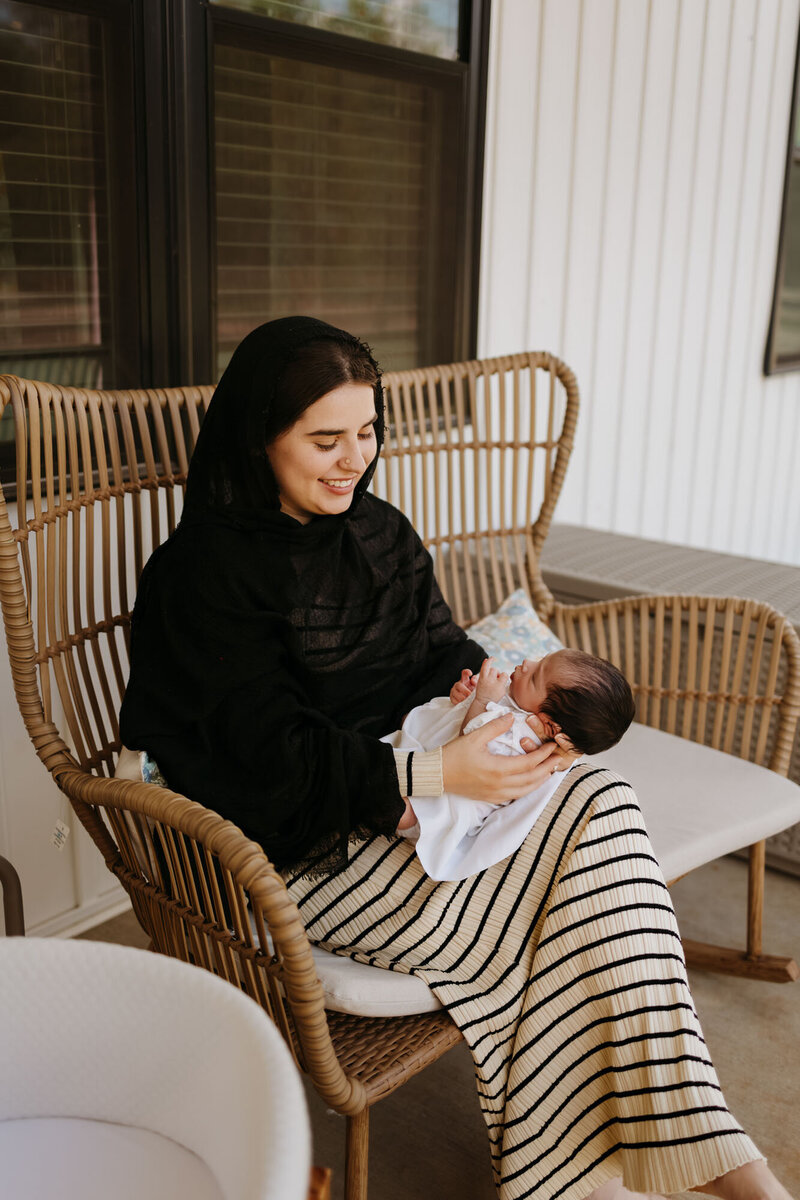 mom sitting with newborn baby
