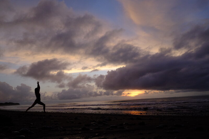 Woman on beach practicing yoga