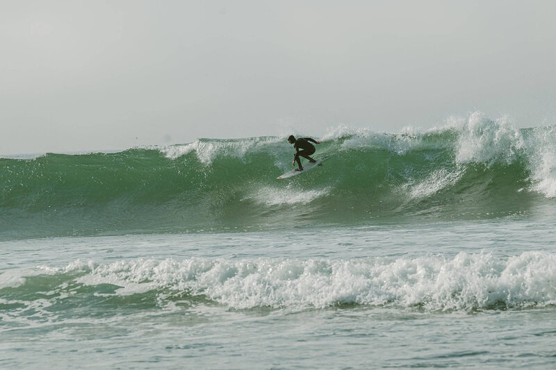 Ocean wave and a surfer on a foggy morning mission at Davenport, near Santa Cruz