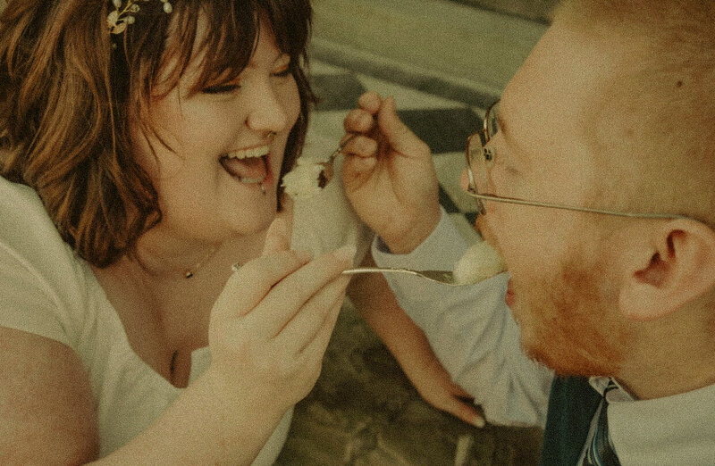 A husband picks up his wife and spins around in a summer field, laughing and embracing their love