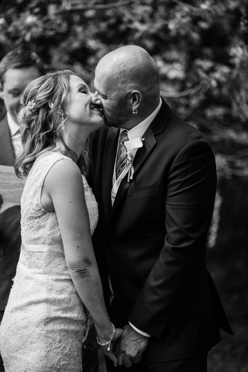 Bride and groom share first kiss in backyard wedding ceremony in Erie, PA