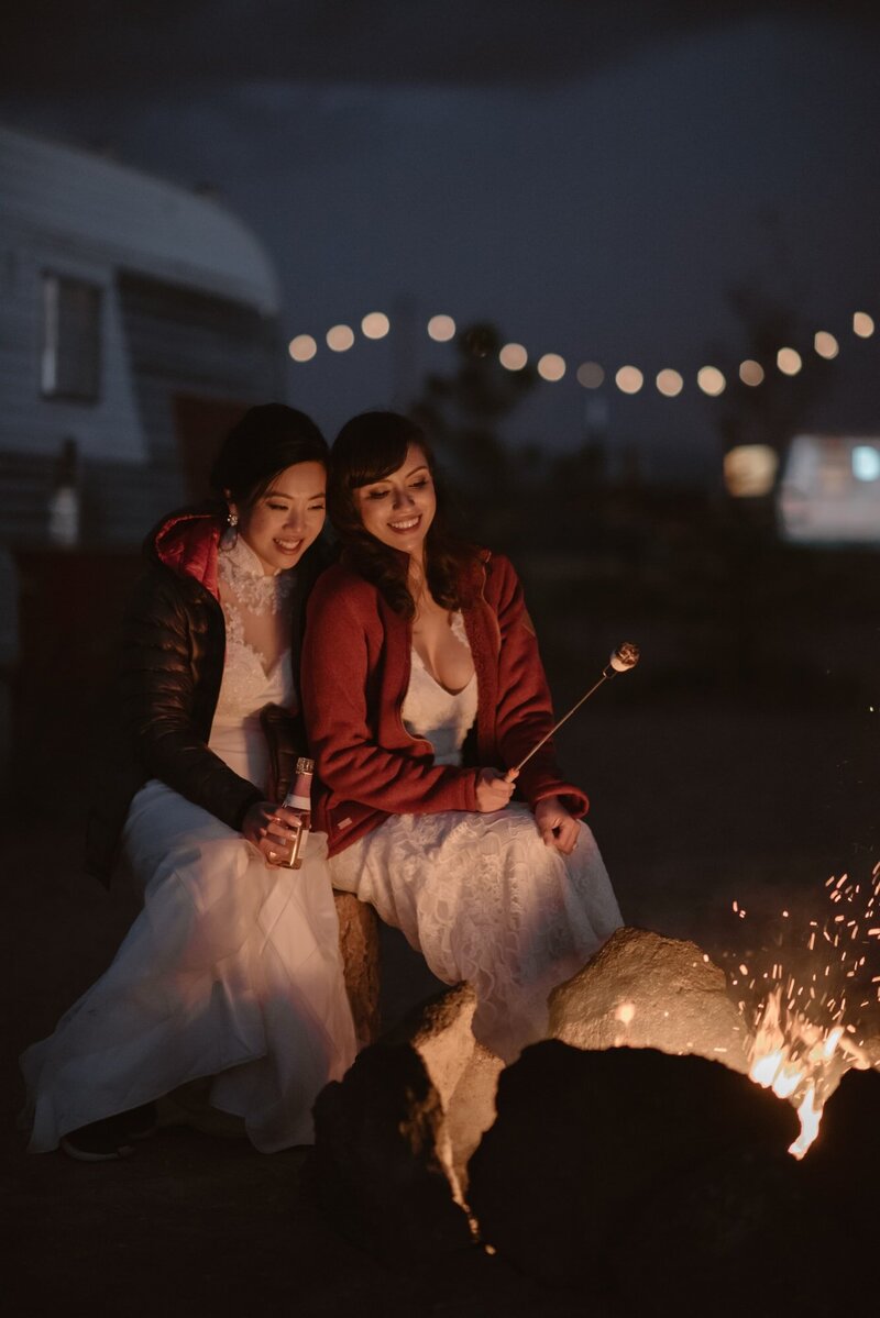 Couple around a campfire during their elopement day