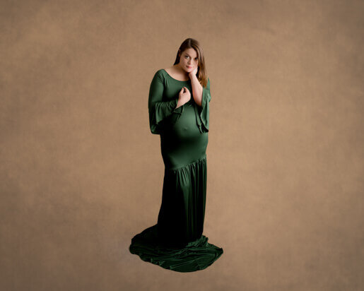 Green maternity gown on a pregnant woman in a Dublin studio.