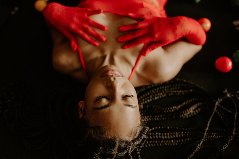 african american woman laying down in red lingerie