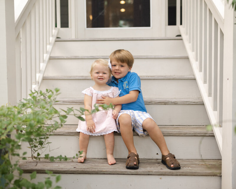 brother and sister sitting on stairs