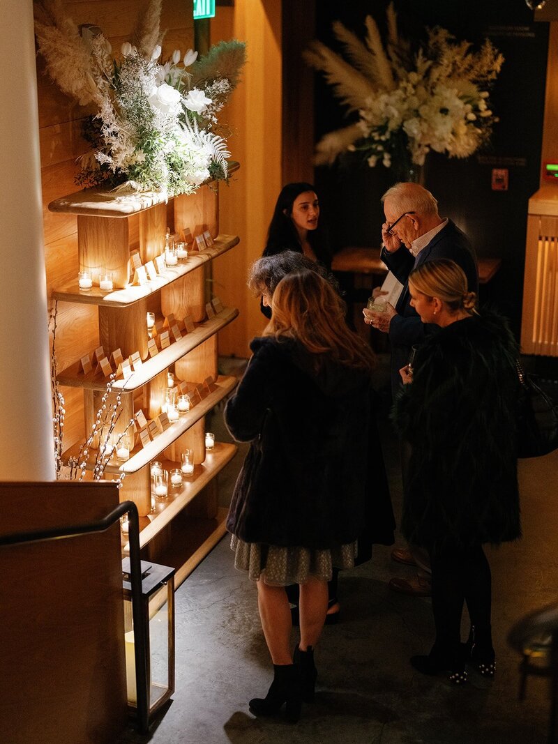 Birthday at Nobu restaurant. Image shows guests looking at seating chart.