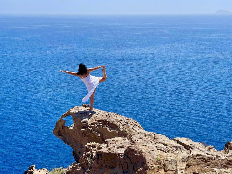Dancer Pose Over the Sea on Greek island