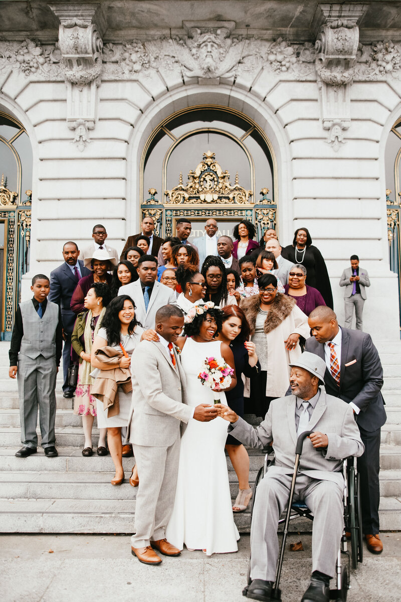 Bride and groom take portraits with their family after San Francisco City Hall elopement